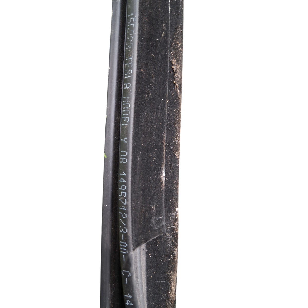My Store OEM Tesla Model Y left door window belt seal with part number 1495722-00-B on green grass background